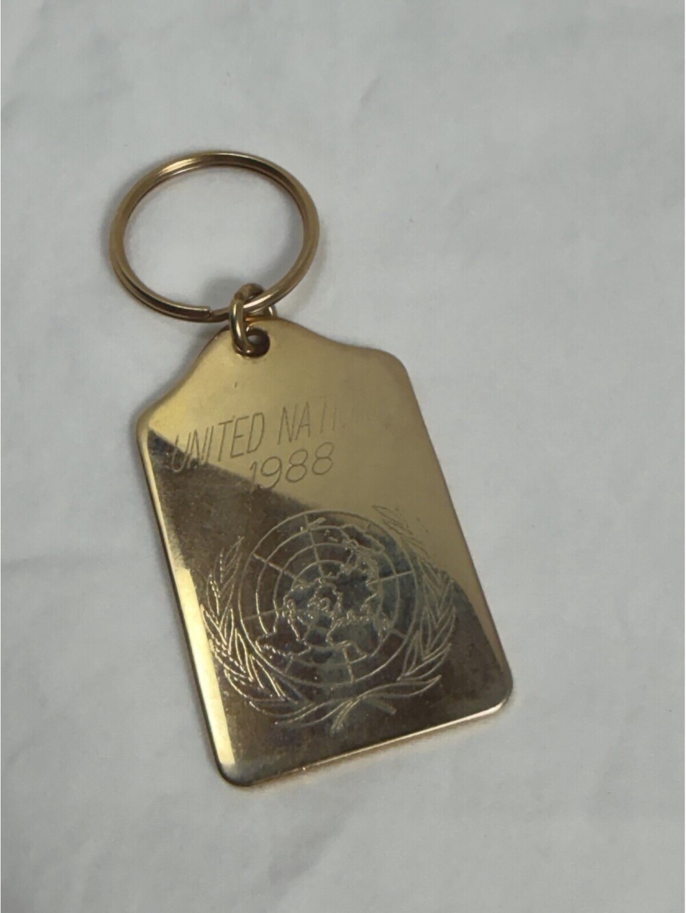Vintage 1988 United Nations Gold Tone Souvenir Keychain